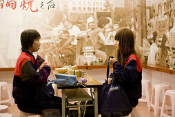 Two women at Taiwanese noodle restaurant Chi Kin Dandanmian, Tainan, Republic of China, Taiwan, Asia