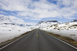 Country road through the snow covered Roldalsfjellet, Hodaland, Norway, Scandinavia, Europe