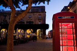 Red telephone cabin in te city in the evening, Valletta, Malta, Europe