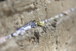 Prayer note tucked between stones in the Wailing Wall, Jerusalem, Israel, Middle East