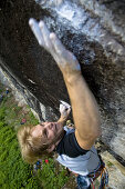 Man climbing on granite wall, Zillertal, Tyrol, Austria