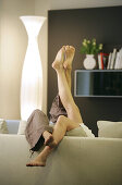 Couple lying on a sofa, legs up