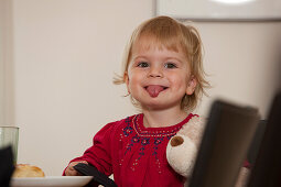 Girl (2 years) sticking out tongue