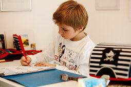 Boy (6 years) doing homework