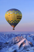 Aerial view of hot-air balloon flying above Alpspitze, Garmisch-Partenkirchen, Wetterstein range, Bavarian alps, Upper Bavaria, Bavaria, Germany, Europe