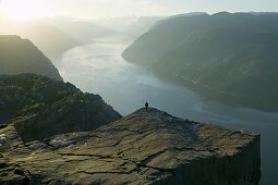 Man stands on Prekkestolen, Lysefjorden, Lyse fjord, Norway