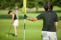 Women are playing golf