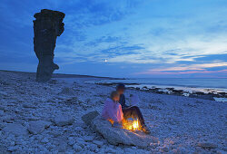 Mother and daughter on beach with sea stacks