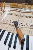 Tool on piano keys, piano making, Bavaria, Germany