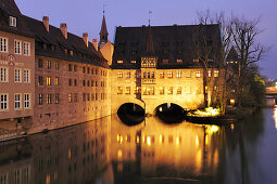 Illuminated Heilig-Geist-Spital with the river Pegnitz at night, Nuremberg, Bavaria, Germany
