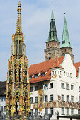 Schoener Brunnen Fountain on the market square and St. Sebaldus church, Nuremberg, Bavaria, Germany