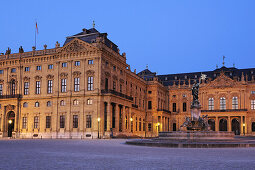 Illuminated fountain Frankoniabrunnen and Wuerzburger residence at night, Wuerzburg, UNESCO World Heritage Site Wuerzburg, Bavaria, Germany