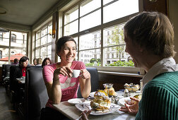 Two women having breakfast in a cafe, Leipzig, Saxony, Germany