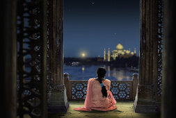 Woman in traditional costume looking at full moon and Taj Mahal, Agra, Uttar Pradesh, India, Asia