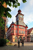 Couple with dog in front of the town hall on the market square, Heppenheim, Hessische Bergstrasse, Hesse, Germany