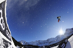 Snowboarder jumping from a kicker, in mid-air performing a jump, funpark Ehrwalder Alm, Tiroler Zugspitzarena, Ehrwald, Tyrol, Austria
