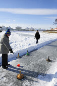 People playing Bavarian curling, Nymphenburg castle in the background, Nymphenburgc astle, Munich, Upper Bavaria, Bavaria, Germany