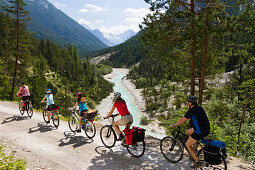Families cycling along Isar Cycle Route, Hinterau Valley, Karwendel range, Tyrol, Austria