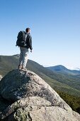 A hiker enjoys the views of the Pemigewasset Wilderness from the summit of Mount Liberty during the summer months  Located in the White Mountains, New Hampshire USA