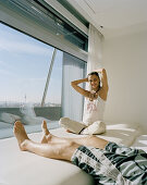 Couple relaxing in the hotel room on the 8th Floor, Designed by Kathryn Findlay, Hotel Silken Puerta America, Madrid, Spain