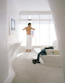 Man getting dressed, Hotel room on the 1st Floor, Designed by Zaha Hadid, Hotel Silken Puerta America, Madrid, Spain