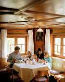 Family in the Restaurant of an organic Hotel , Hirschegg, Kleinwalsertal, Austria