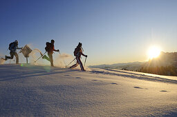 People snowshoeing in snowy landscape, Eggenalm, Reit im Winkl, Chiemgau, Upper Bavaria, Bavaria, Germany, Europe