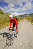 Cyclist at Campo Imperatore, summit of Corno Grande, Gran Sasso National Park, Abruzzi, Italy, Europe