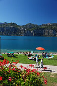 People sunbathing, Malcesine, Lake Garda, Veneto, Italy