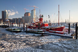 Fire ship in front of HTC Hanseatic Trade Center and Elbphilharmonie in winter, the Free and Hanseatic City of Hamburg, Germany, Europe