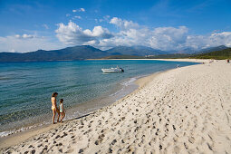 Mother and daughter walking along Portigliolo beach near Propriano, Golfe de Valinco, , Corsica, France, Europe