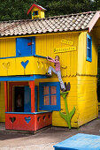 Girl climbing on Pippi Longstocking house, Astrid Lindgren Värld, Astrid Lindgren World, Vimmerby, Smaland, South Sweden, Europe