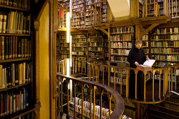 Monk at the library at Maria Laach abbey, Eifel, Rhineland-Palatinate, Germany, Europe