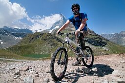 Elijah Weber mountain biking in the shadow of The Matterhorn at Schwarzsee Paradise high in the Swiss Alps above the city of Zermatt in Switzerland