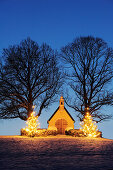 Illuminated chapel with two illuminated Christmas trees, lake Chiemsee, Chiemgau, Upper Bavaria, Bavaria, Germany, Europe