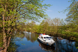 Houseboat on a kanal near lake Ellbogensee, Mecklenburg Lake District, Mecklenburg-Pomerania, Germany