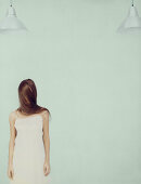 Young woman standing with face wrapped in hair