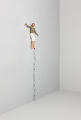 Woman balancing on one foot on top of stack of water bottles