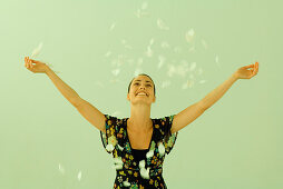 Woman tossing flower petals into air