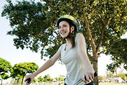Teen girl riding bicycle, portrait