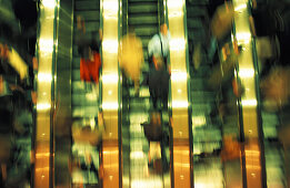 People on escalators, blurred