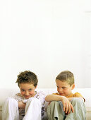 Two boys sitting side by side