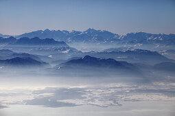 Aerial photo of northern Chiemsee in winter, view south towards the Chiemgau and Austrian Alps, Bavaria, Germany