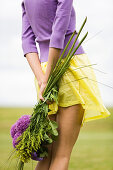 Young woman holding a bouquet of flowers