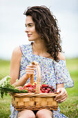 Young woman with a basket full of fruits