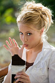 Portrait of a young woman eating chocolate