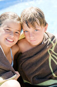 2 children wrapped in towel