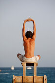 Cape Verde Peninsula, Sal, Santa Maria beach, teen boy in yoga attitude