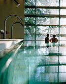 Couple in an indoor pool looking out of a picture window,  Vigiljoch, Lana, Trentino-Alto Adige, South Tyrol, Italy