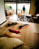 Woman in Superior Room Chalet, Mango Lodge, view over Anse Volbert, Bahia Ste. Anne, Praslin, Republic of Seychelles, Indian Ocean